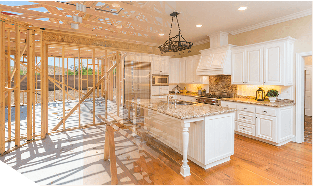A kitchen with white cabinets and wooden floors.
